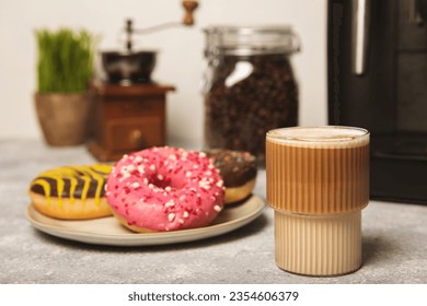 Modern coffee machine with a cup and donut on the kitchen table. Coffee house. Modern espresso coffee machine with a cup in the kitchen. Preparation of a fragrant hot drink. Place for text.Copy space. - Powered by Shutterstock