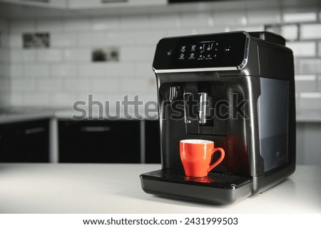 Modern coffee machine on table in kitchen.