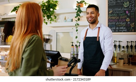 Modern Coffee Shop Bar Handsome Barista Guy With A Cute Smile Giving The Order To The Customer Lady And Typing On The Terminal To Purchase The Pay