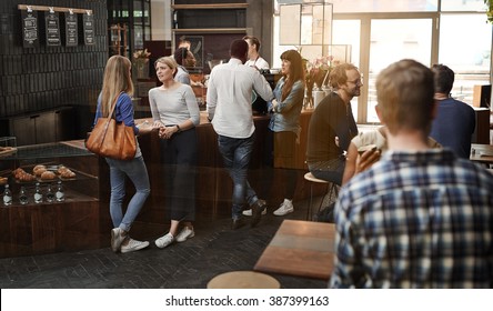 Modern coffee shop with customers standing at counter and sittin - Powered by Shutterstock