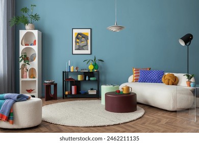 Modern and colorful interior of living room with design boucle sofa, mock up poster, shelf, plants, decorations and personal stuff. Home decor.	 - Powered by Shutterstock