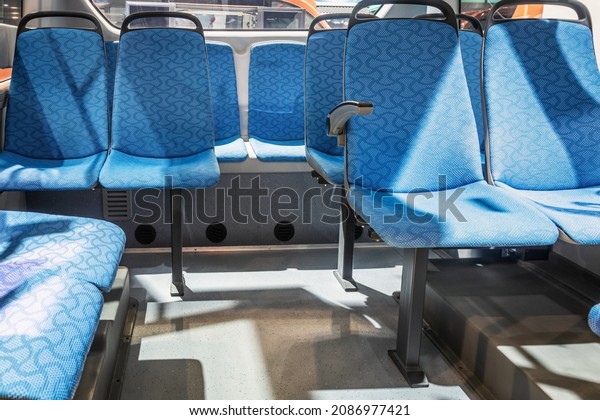 modern and\
comfortable city bus, an electric bus or a hydrogen bus cabin with\
suspended empty passenger\
seats