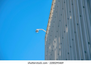 Modern Commercial Building With Cctv Security Camera In Tucson Arizona. View Of A Highrise With Video Surveilance Camera Installed At The Roof For Safety.