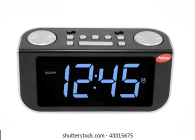 Modern Compact Digital Electronic Clock From Radio. It Is Isolated On The White. MAss Production.