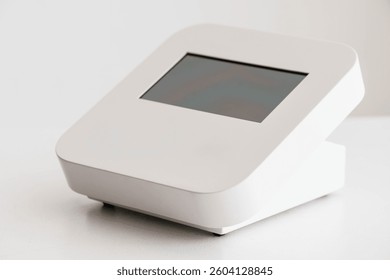 Modern Compact White Electronic Device with Digital Display Screen on White Background.