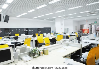 The Modern Company Office Interior With Computer Tables And Chairs.