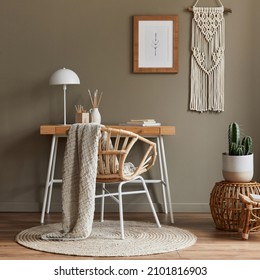 Modern Composition At Boho Interior Of Home Office Room With Wooden Desk, Stylish Armchair, Bamboo Shelf, Carpet, Macrame, Mock Up Poster Frame, Office Supplies, Decoration And Personal Accessories.