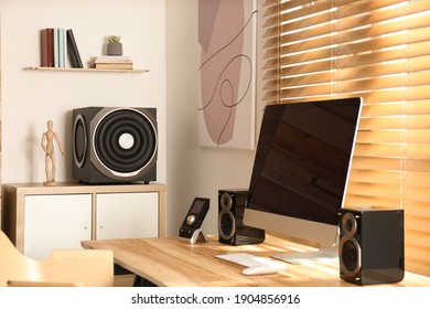 Modern computer with audio speaker system in bright room