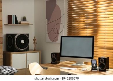 Modern computer with audio speaker system in bright room