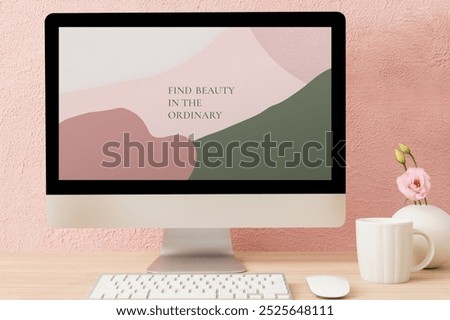 Modern computer desktop setup, pink and green abstract art. Cozy workspace with a pink wall, coffee mug, and flower. Inspiring and stylish decor. Computer screen mockup in pink wall room.