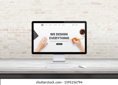 Modern Computer Display With Web Design Agency Page On Office, Studio Desk. Flat Design Concept. Modern Flat Design Interior With Brick Wall In Background