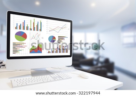 Modern computer with keyboard and mouse on table showing charts and graph against office background in blue tone, Analysis Business, Statistics Concept.