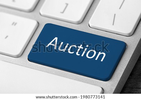 Modern computer keyboard with text Auction on button, closeup
