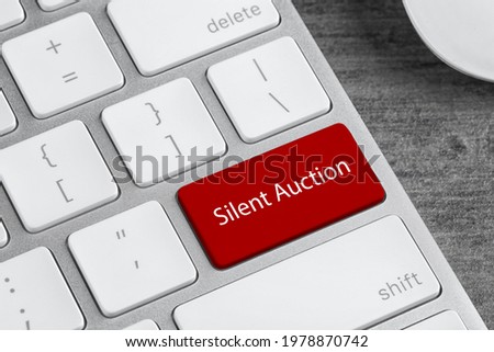 Modern computer keyboard with text Silent Auction on button, closeup
