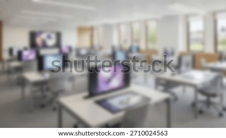 Modern Computer Lab Blurry interior of desks and screens in learning center.