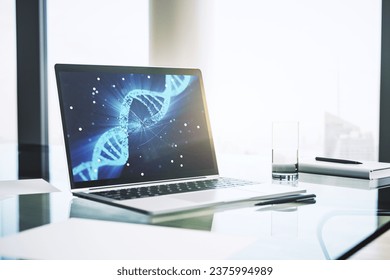 Modern computer monitor with creative DNA hologram. Bio Engineering and DNA Research concept. 3D Rendering - Powered by Shutterstock