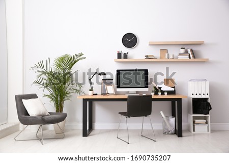 Modern computer on table in office interior. Stylish workplace