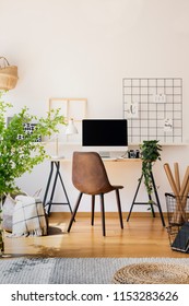 Modern Computer Screen On An Industrial Desk By A White Wall In A Warm, Sunny Study Space Of A Teenager Bedroom Interior