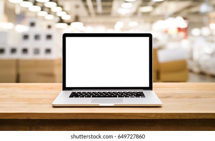 Modern Computer,laptop With Blank Screen On Table With Blur Store Factory Background