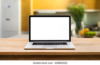 Modern Computer,laptop With Blank Screen On Wooden Table With Blur Kitchen Backgrounds