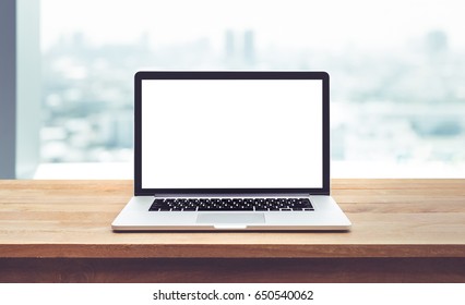 Modern computer,laptop with blank screen on wood table with office window view backgrounds