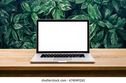 Modern Computer,laptop With Blank Screen On Table With Green Leaf Backgrounds