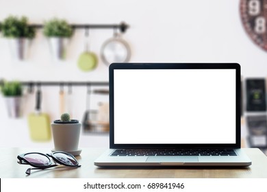 Modern computer,laptop with blank screen on table with blur modern kitchen backgrounds - Powered by Shutterstock