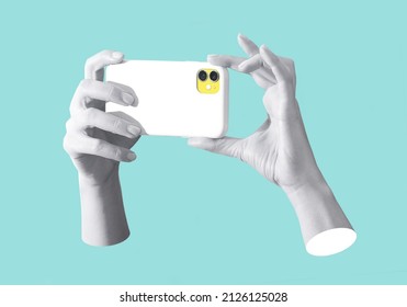 Modern conceptual art poster with a  hands holding a smartphone in a mas surrealism style. Contemporary art collage on a blue background - Shutterstock ID 2126125028
