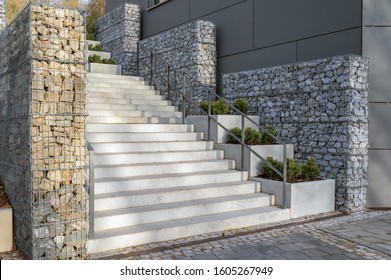 Modern concrete staircase with gabion fence as an eye-catcher