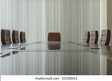 Modern Conference Room With Brown Leather Chair And Glass Surface Table