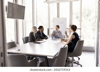 In modern conference room group of multiracial teammates solve joint task, share solutions, strategy, express opinion working on collaborative project seated at desk. Negotiations, meeting, business - Powered by Shutterstock
