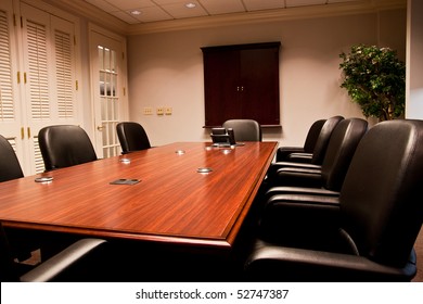 A Modern Conference Room With Leather Chairs And Mahogany Table