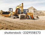 Modern construction machinery at a construction site in a quarry. Powerful modern equipment for earthworks. Rental of construction equipment. Excavator, dump truck, bulldozer, loader