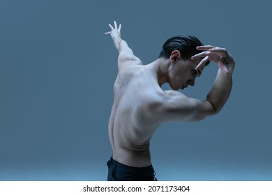 Modern, Contemp. One Young Man, Flexible Male Dancer Dancing Isolated On Old Navy Studio Background. Art, Motion, Action, Flexibility, Inspiration Concept. Flexible Artist. Beauty Of Male Body