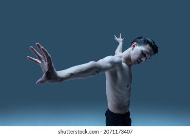 Modern, Contemp. One Young Man, Flexible Male Dancer Dancing Isolated On Old Navy Studio Background. Art, Motion, Action, Flexibility, Inspiration Concept. Flexible Artist. Beauty Of Male Body