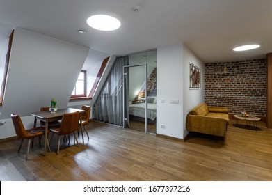 Modern Contemporary Loft Interior Of Studio Apartment. Table And Chairs. Private House. Bedroom.