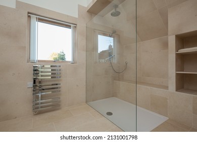 Modern contemporary walk in shower room with chrome towel rail - Shutterstock ID 2131001798