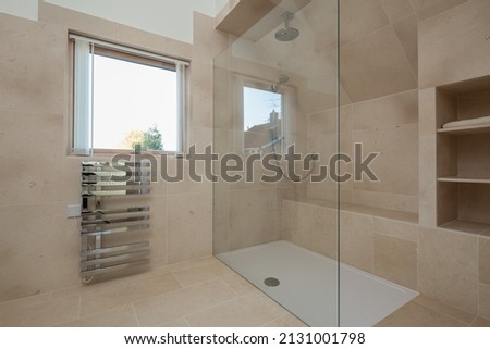 Modern contemporary walk in shower room with chrome towel rail