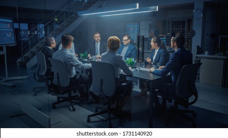 In The Modern Corporate Meeting Room: Diverse Group Of Businesspeople, Lawyers, Executives And Directors Talking, Negotiating, Working With Documents, Planning Strategy. Late At Night In The Office