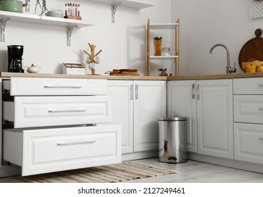 Modern Counters With Opened Drawers And Trash Can In Kitchen Interior