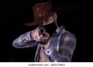 Modern Cowboy With A Musket And A Protective Veil On His Head Has A Leather Hat