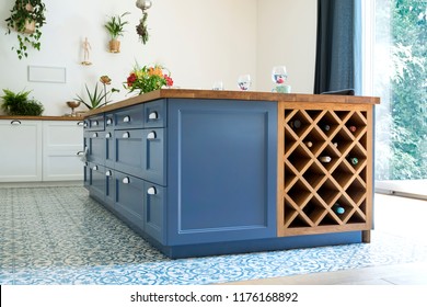 Modern and cozy kitchen interior with shelfs, accessories and plants. Bright and sunny space.