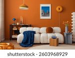 Modern cozy living room with white boucle sofa, orange wall and eclectic decor in bold colors.