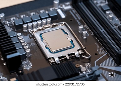 Modern CPU processor installed on a brand new motherboard, object detail, extreme closeup, nobody. Simple generic powerful high end gaming CPU up close, desktop PC up close, parts, components upgrade