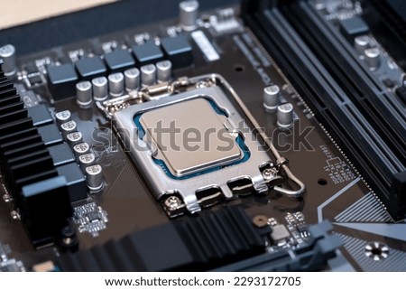 Modern CPU processor installed on a brand new motherboard, object detail, extreme closeup, nobody. Simple generic powerful high end gaming CPU up close, desktop PC up close, parts, components upgrade
