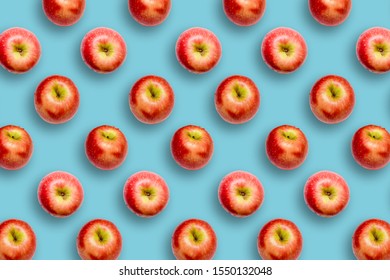 Modern creative healthy snack food concept Pattern of apples on bright colourful blue background in minimalist style