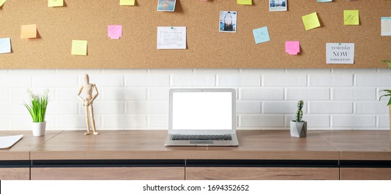 Modern creative workplace with laptop notebook mock up white empty screen on desk with moodboard sticky notes at work space home office room interior. Designer table with computer and stickers. - Powered by Shutterstock