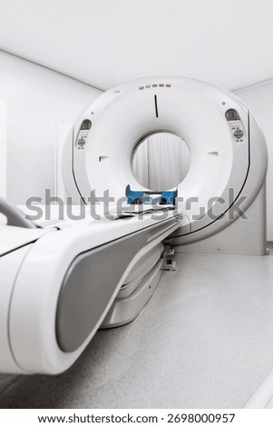 Modern CT scanner machine positioned in a bright medical facility, highlighting advanced technology and a sterile environment for patient diagnostics