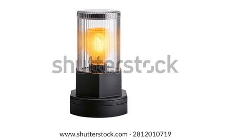 Modern cylindrical table lamp with ribbed glass shade and glowing filament bulb