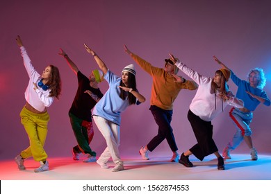 Modern dancers posing in front of studio background, performing modern dance element, professional group of dancers preparing for concert, practicing movies